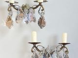 two wall sconces that are hanging on the wall