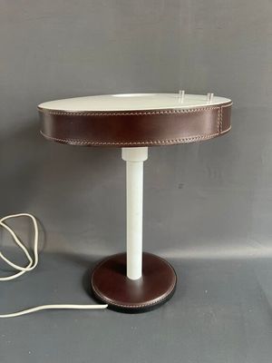 lampe de table en cuir marron avec un pied blanc et un cordon blanc