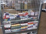 a metal cart with many books on it in a warehouse