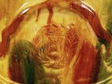 a close up of a bowl with a painting on it