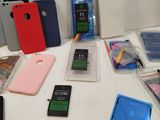 several cell phones are sitting on a table with other items on it