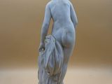 statue of a woman holding a vase in her right hand