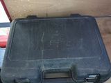 a black case sitting on top of a red box