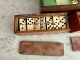 a box of dominos sitting on top of a marble table