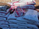 une grande pile de vêtements posée sur une pile de sacs