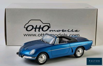 an old model of a blue sports car in front of a box