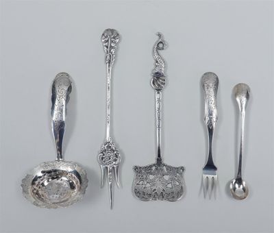 several silver spoons and forks are lined up on a white surface