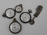 four different types of pocket watches are displayed on a white surface