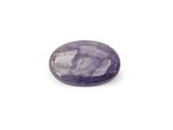 a close up of a purple stone on a white surface
