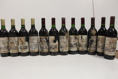 several bottles of wine are lined up on a table