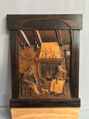 sculptures représentant un homme et une femme assis devant une cheminée