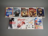 several video games are lined up on a table in front of a wall