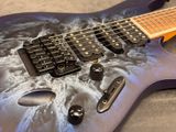 a close up of an electric guitar with a purple body