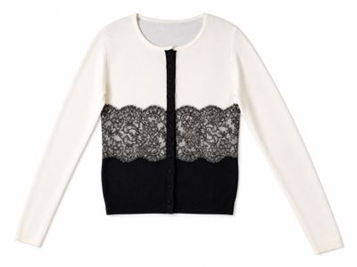 a white and black cardigan sweater with black lace trim
