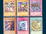 six cards of different colors and designs on a blue background