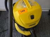 a yellow vacuum that is sitting on the floor