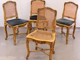 four chairs are lined up in a row in a room