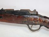 an old rifle with a wooden barrel and a metal handle