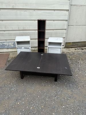 a table with two chairs and a book shelf on the ground