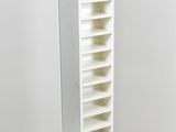 a tall white bookcase with many shelves on it