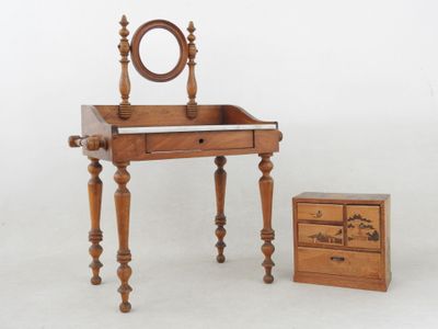 a small wooden vanity with a mirror on top of it