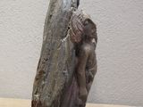 statue of a woman holding a rock on a table