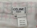 a close up of a label on a white dress with pink flowers