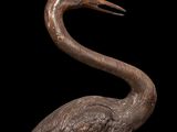 a close up of a statue of a bird on a black background