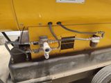 a yellow machine that is sitting on the side of the road