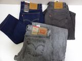 three pairs of levi ' s jeans sitting on top of each other
