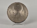 an image of a silver coin with a woman ' s face on it