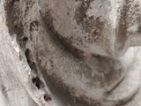 a close up of a statue of a man with a hat on