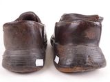 pair of old worn brown leather shoes on white background