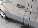 a close up of a car door handle on the side of the road