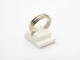 a close up of a ring on top of a white block