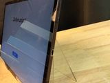 a tablet computer sitting on a wooden table with a black background