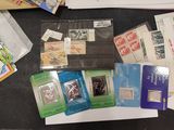 many different types of stamps and envelopes laid out on a table