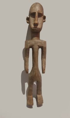 an image of a wooden sculpture of a man with a bald head