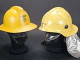 two yellow hard hats are sitting on top of each other