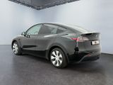 the tesla model y is parked in the garage