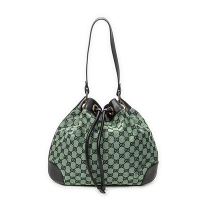 un sac à main vert et noir avec des anses noires sur fond blanc