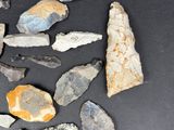 several pieces of rock and stone are arranged on a black surface