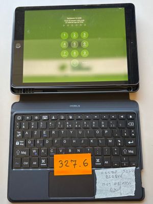 a laptop and a tablet on a table with a notepad