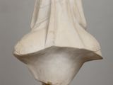 a white marble bust of a woman with a veil on her head