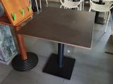 tables and chairs in a restaurant with a climbing wall on the wall