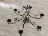 a candle holder that is on the floor in the room
