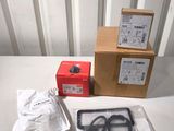 a box of scissors and a pair of scissors on a table