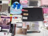 a lot of makeup and other items on the table