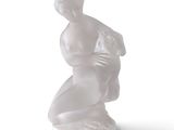 a white statue of a woman with a bag on her back