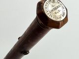 a close up of a wooden stick with a clock on it